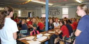 Over 70 members of the Mater Dei FBLA attended the first meeting of the school year which was run by FBLA president Clare Chiarolanza (left) and treasurer Haley Johnson (right). The meeting began with the introduction of officers. Other agenda items included the planning of data collection for the Buzz Book, the organizing of a Krispy Kreme donut sale before school, the forming of committees for the candy cane sale and etiquette dinner, and discussing future FBLA events. This meeting also served to provide information about the FBLA to freshmen.