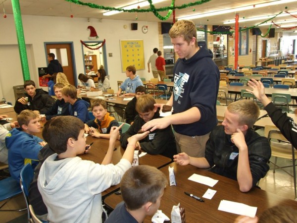 Student Ambassador Joe Hemann serves brownies to eighth graders from St. Rose Grade School during the students’ eighth grade visit to Mater Dei. The students were able to visit classes in progress, tour parts of the campus, and partake in a snack of brownies and milk in the cafeteria. Also participating in eighth grade visits this past week were students from St. Paul-Highland and St. Clare-O’Fallon. The visits for other area eighth graders will continue throughout December. 