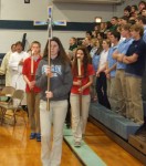 Leading the procession for the Catholic Schools Week Mass are cross bearer Morgan Dermody and candle bearers Chandler Haar and Jennifer Mioux.