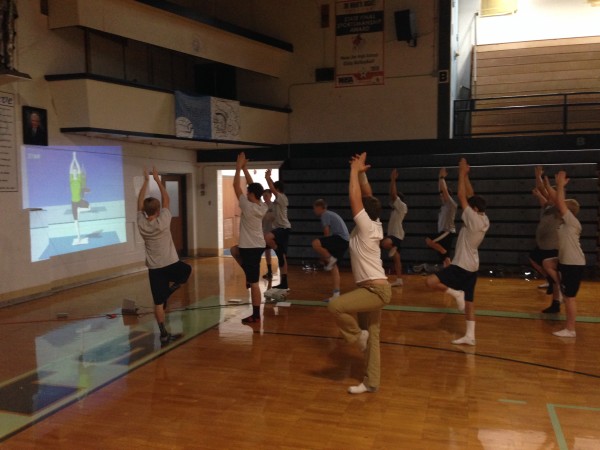 Freshmen boy's Physical Education practice Yoga during class.