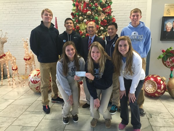 MD FBLA members present Dr. Renato Rivera a check for $1,270 to used for the  Operation Giving Back Bohl Mission
